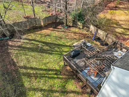 a view of a chair and table in back yard of the house