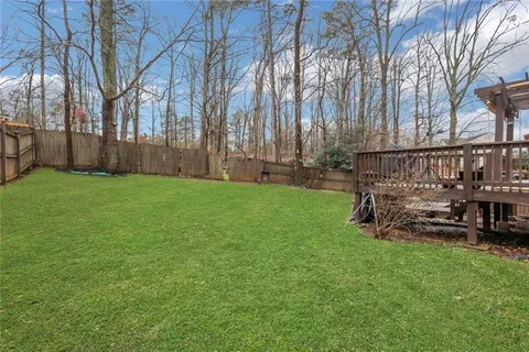 a kitchen with granite countertop a stove a sink and a microwave