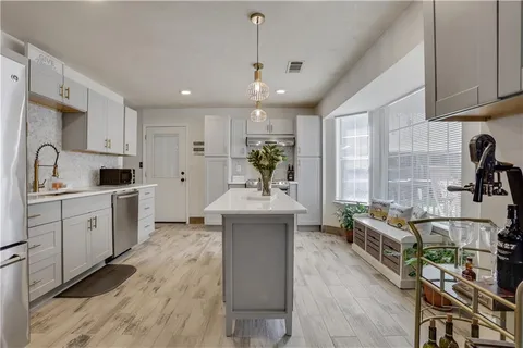 a kitchen with sink cabinets and window