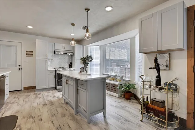 a kitchen with a sink appliances and cabinets