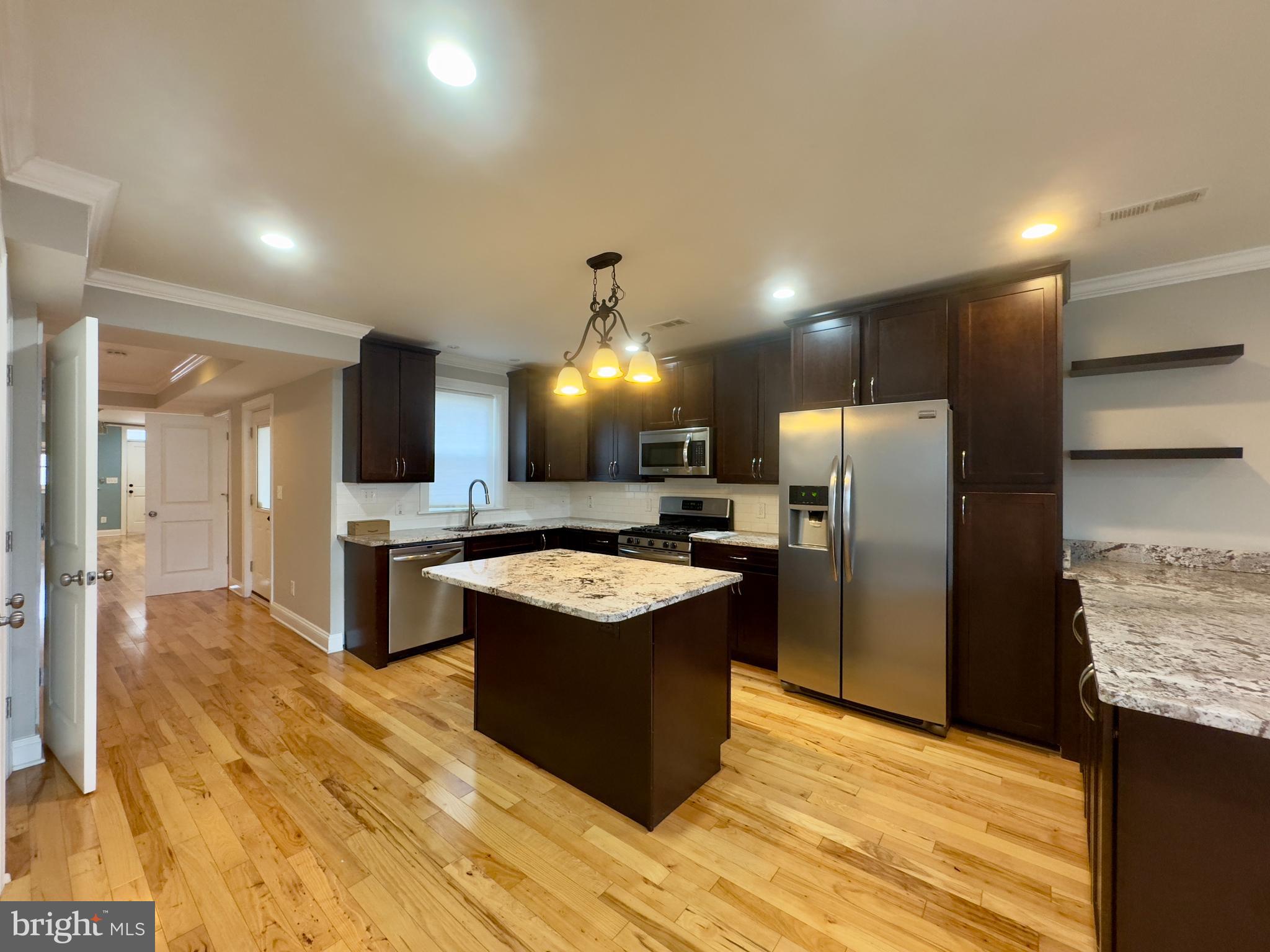 3533 Falls Road Baltimore, MD 21211 - Photo 14 of 20 a kitchen with stainless steel appliances granite countertop a refrigerator a sink and a stove