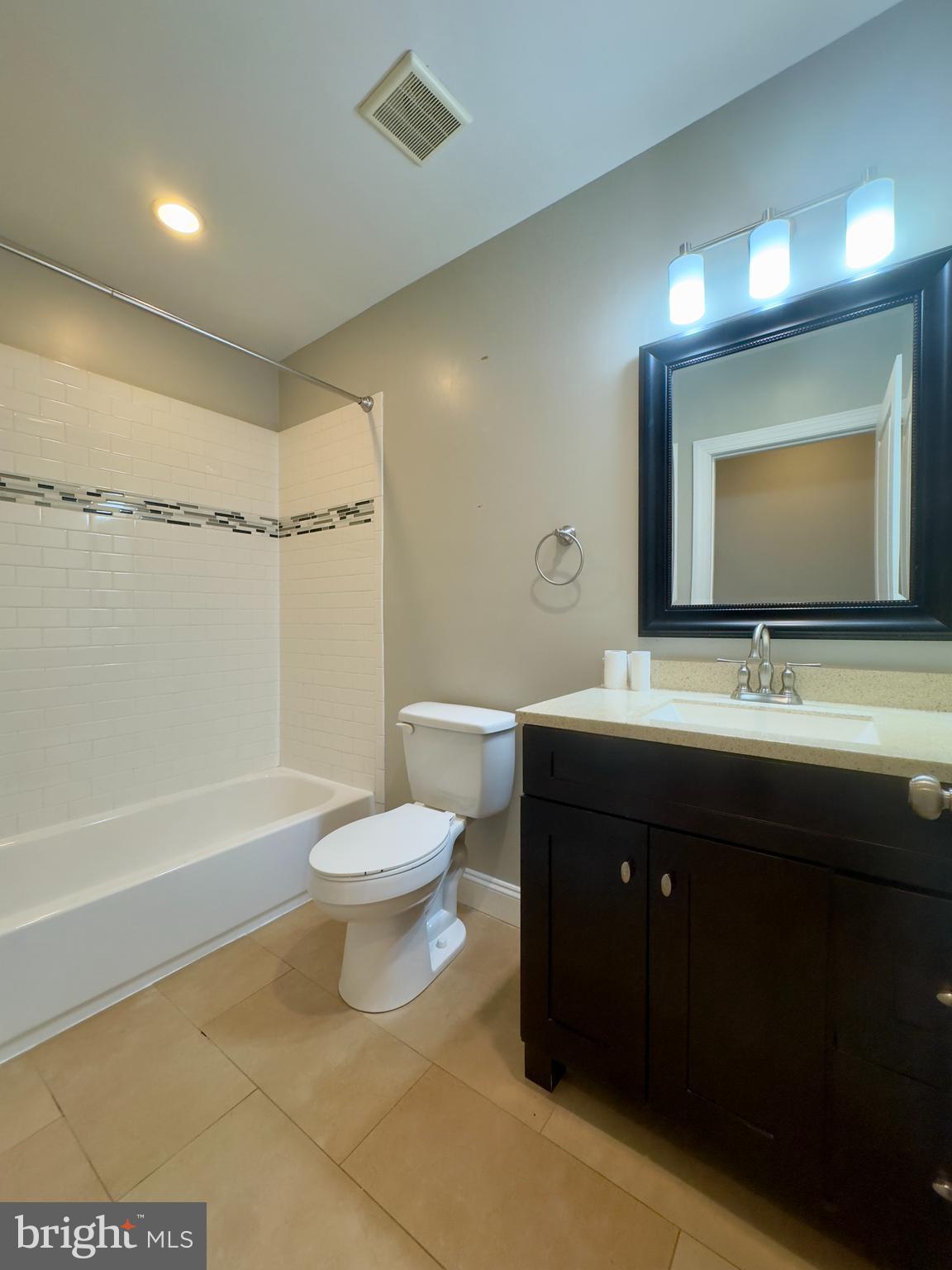 3533 Falls Road Baltimore, MD 21211 - Photo 20 of 20 a bathroom with a double vanity sink toilet mirror and bathtub
