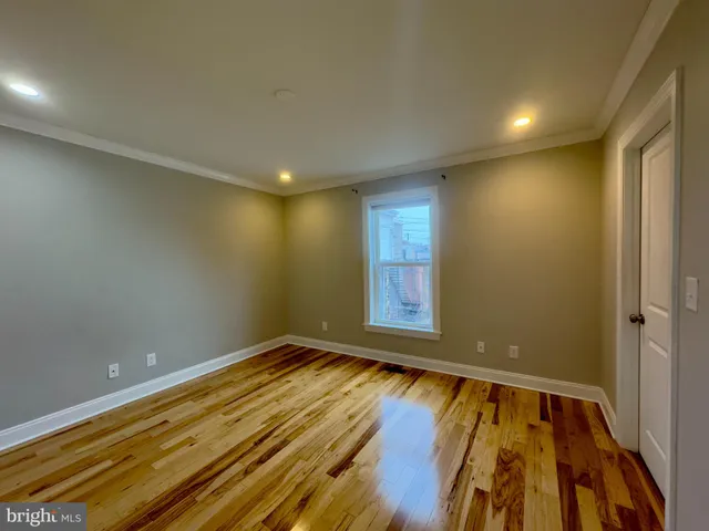 a view of room with window and wooden floor