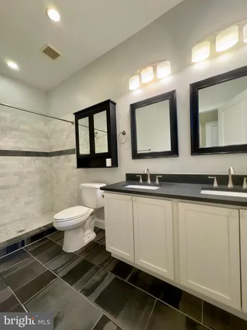a bathroom with a sink toilet and mirror