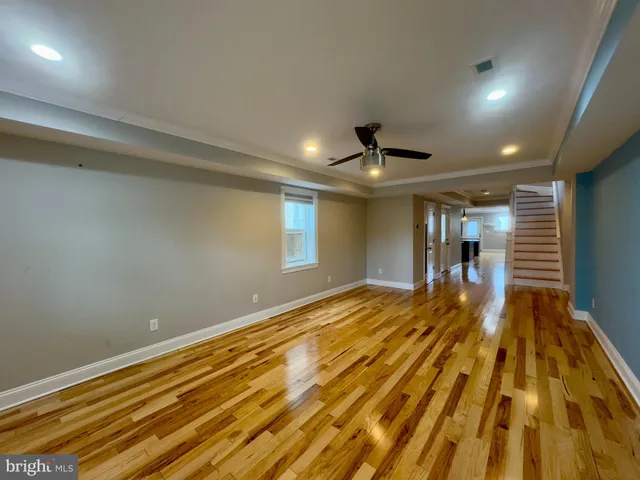 a view of an empty room with wooden floor