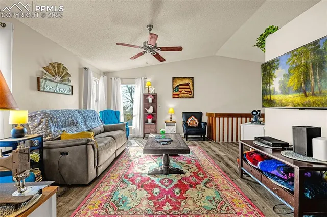 a view of a a dining room with furniture window and wooden floor