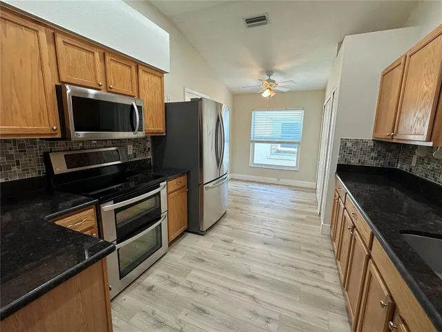 a bathroom with a sink a toilet a mirror and vanity