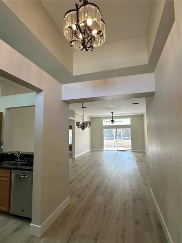 an empty room with wooden floor closet and fan