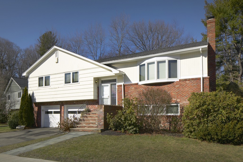521 Clinton Road Brookline, MA 02467 - Photo 1 of 8 a front view of a house with a garden