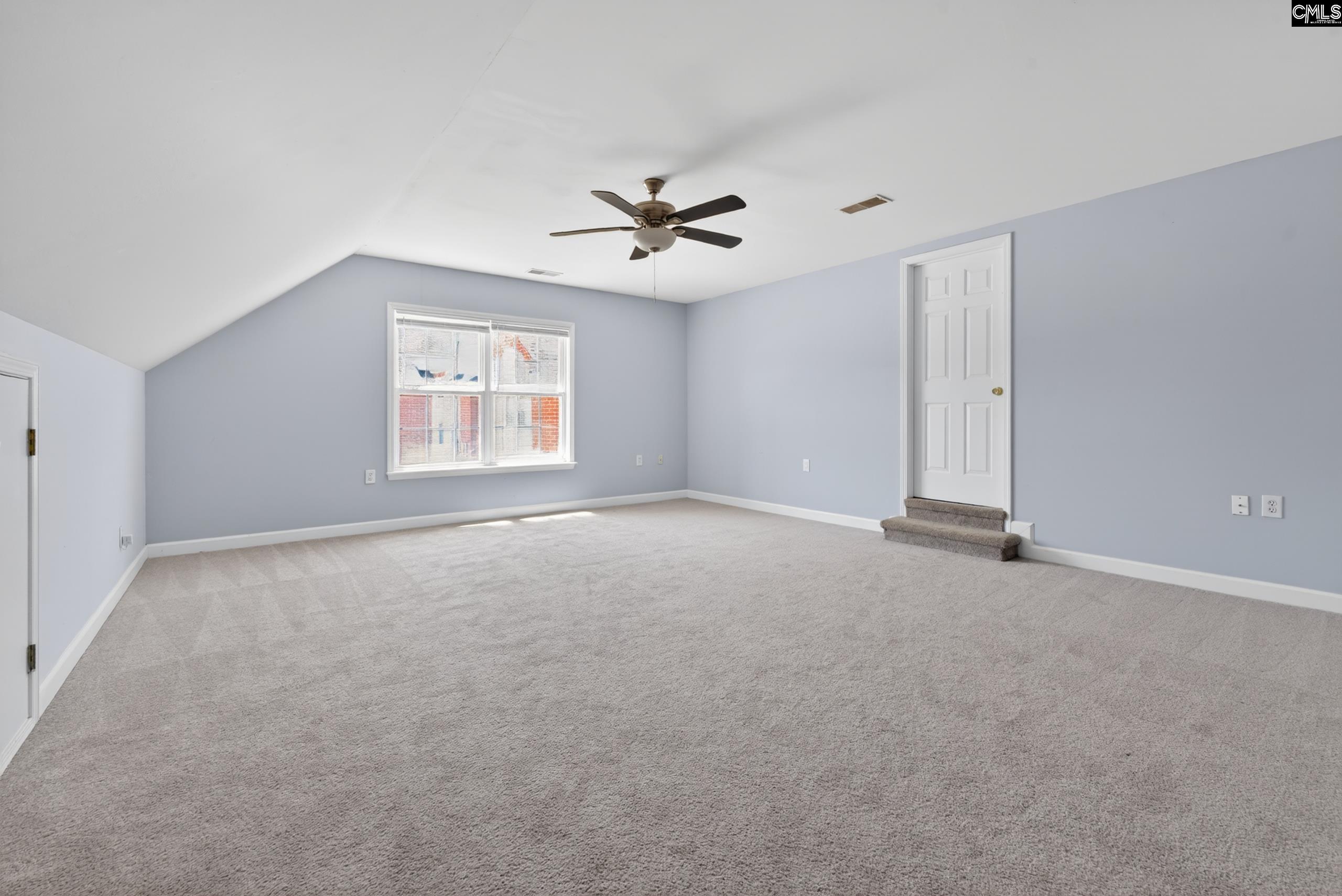 219 Plantation Pointe Drive Elgin, SC 29045 - Photo 11 of 56 an empty room with windows and ceiling fan