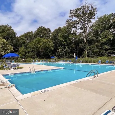 a view of a swimming pool with an outdoor space and seating area
