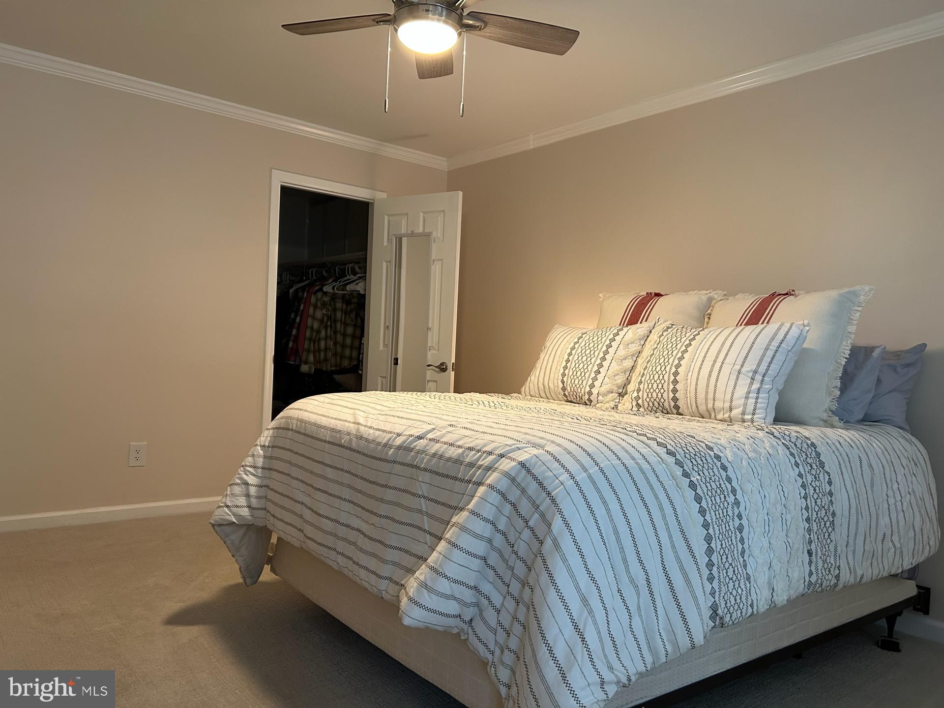 25 South Church Road, Unit 89 Maple Shade, NJ 08052 - Photo 16 of 24 a bedroom with a bed and a chandelier