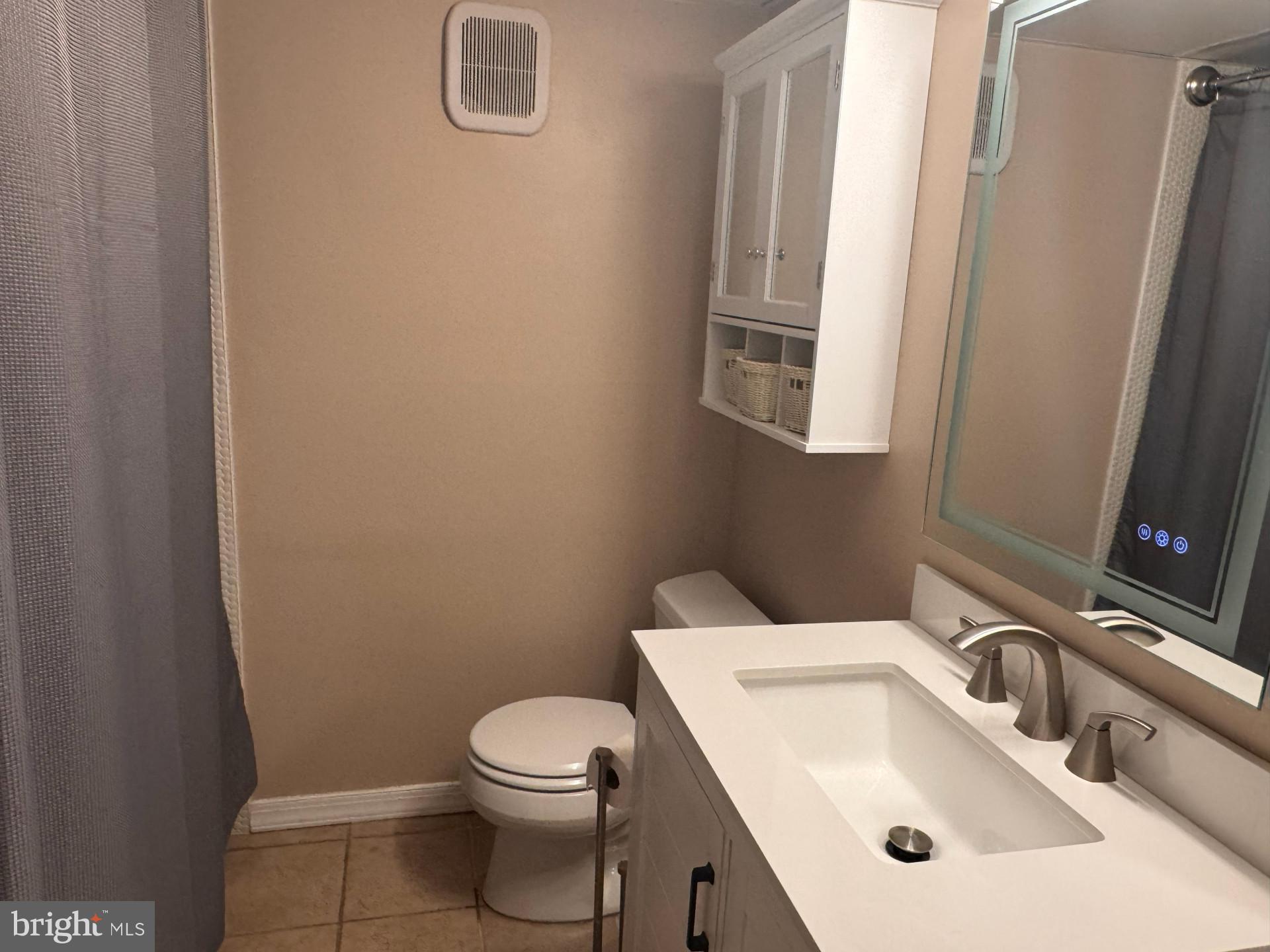 25 South Church Road, Unit 89 Maple Shade, NJ 08052 - Photo 19 of 24 a bathroom with a sink a toilet and a mirror