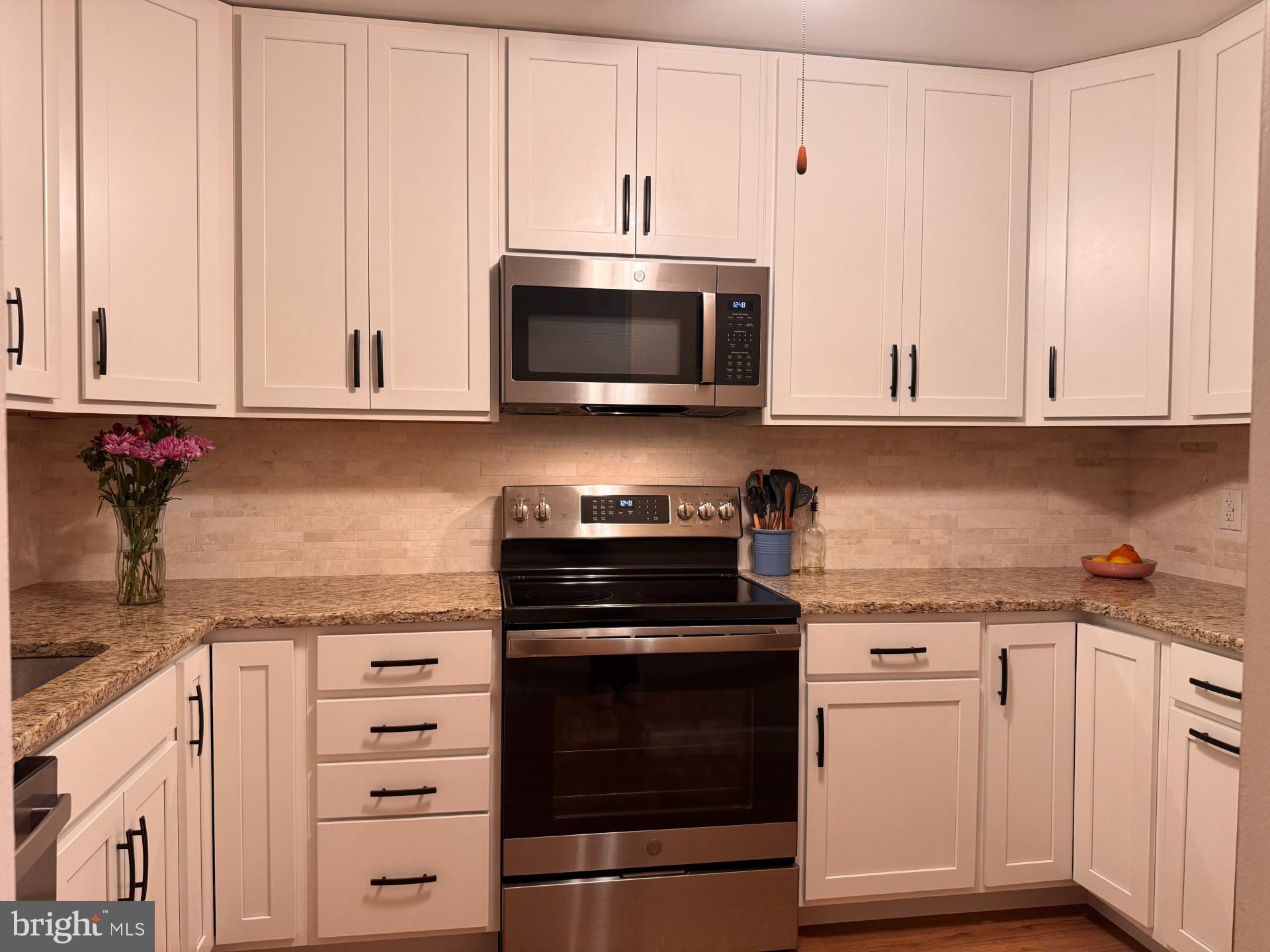 25 South Church Road, Unit 89 Maple Shade, NJ 08052 - Photo 4 of 24 a kitchen with granite countertop white cabinets and stainless steel appliances