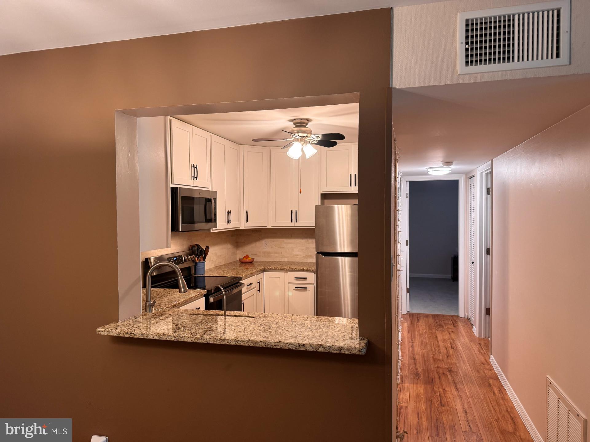 25 South Church Road, Unit 89 Maple Shade, NJ 08052 - Photo 7 of 24 a kitchen with a refrigerator and a view of living room
