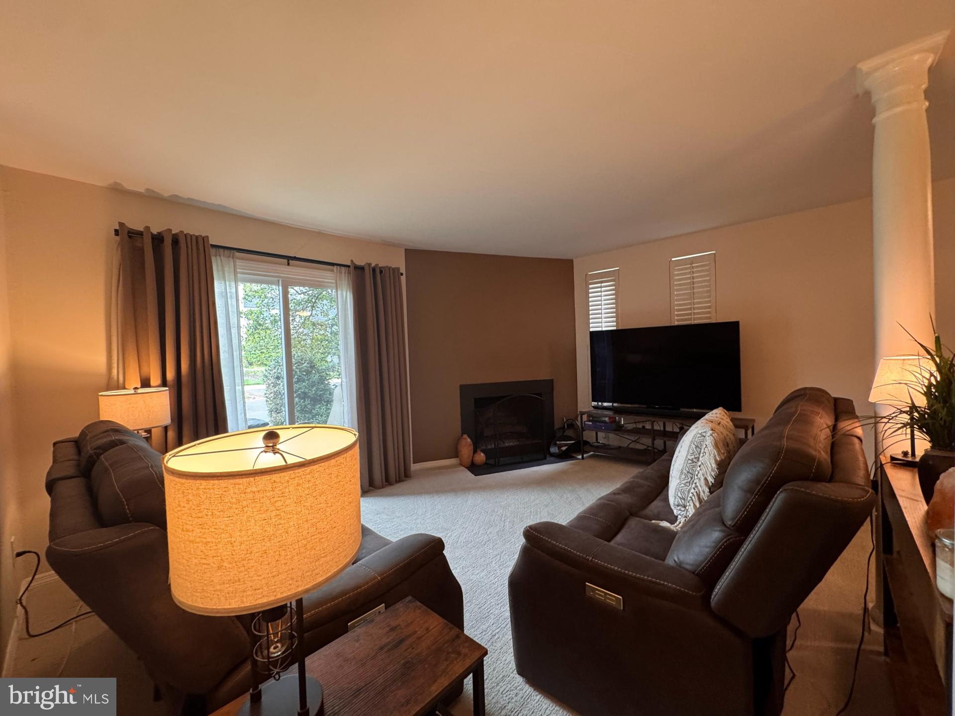 25 South Church Road, Unit 89 Maple Shade, NJ 08052 - Photo 8 of 24 a living room with furniture a flat screen tv and a fireplace