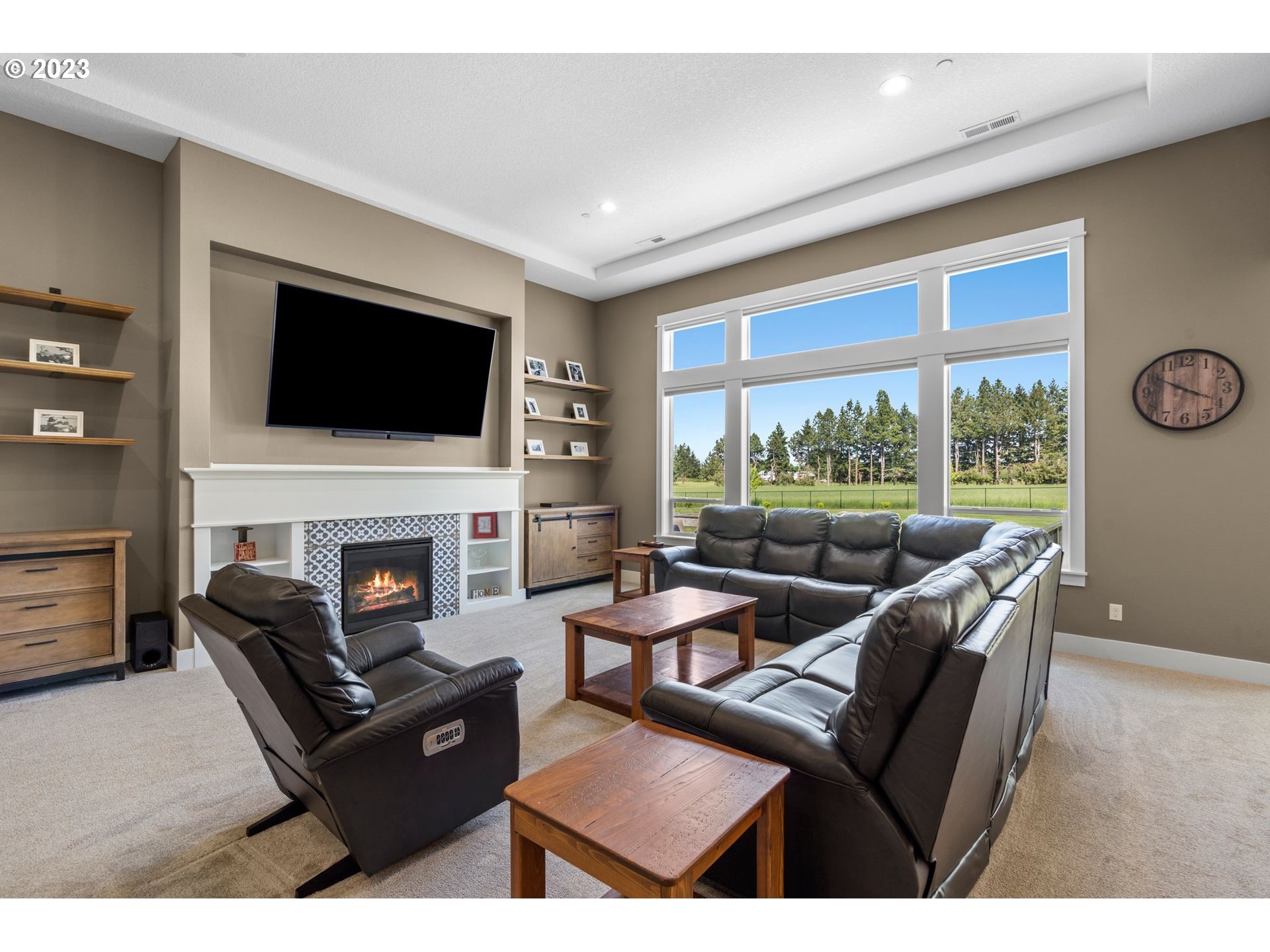 17792 South Strowbridge Road Oregon City, OR 97045 - Photo 17 of 32 a living room with furniture a fireplace and a flat screen tv
