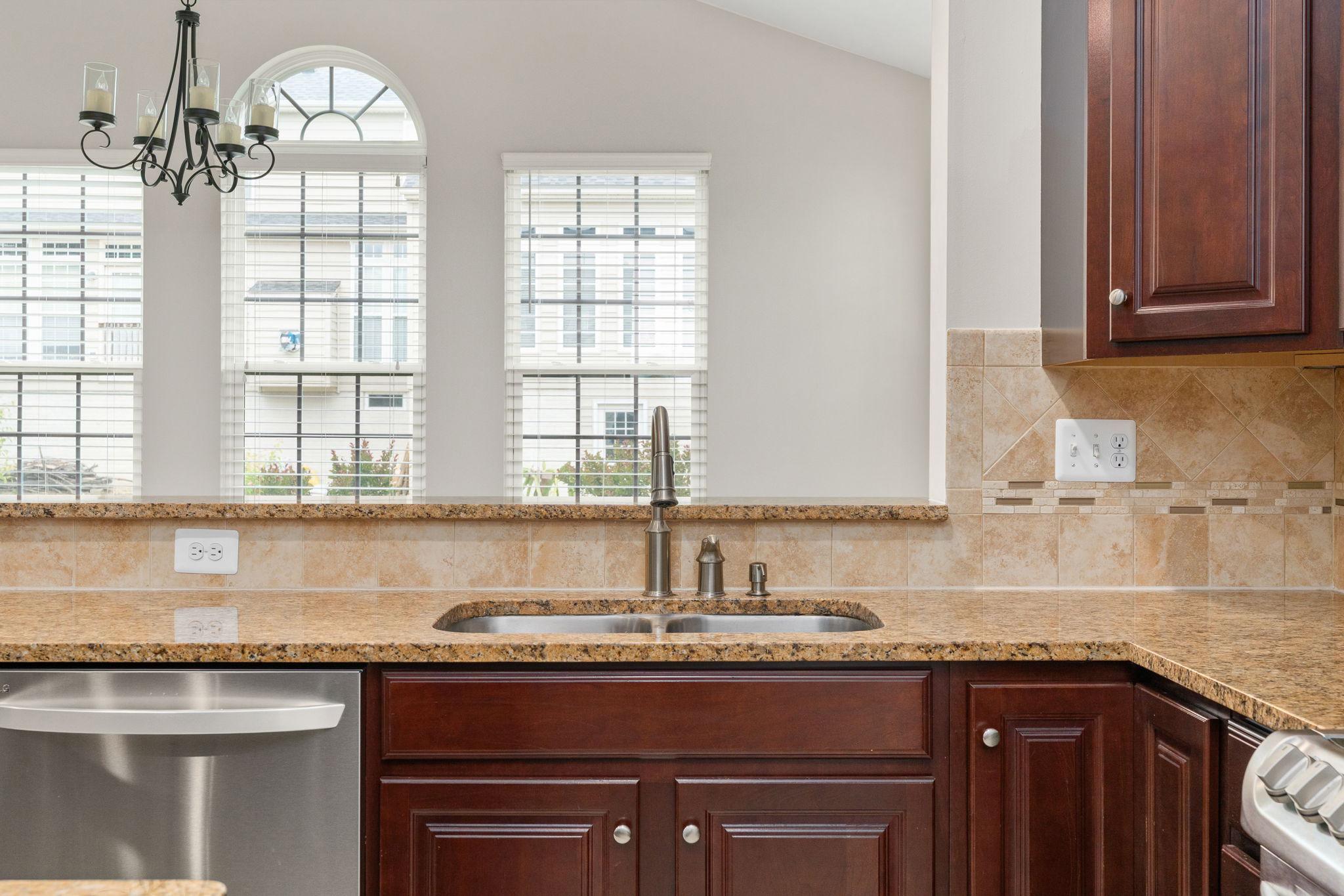 9417 Reservoir Road Fredericksburg, VA 22407 - Photo 18 of 76 a kitchen with granite countertop a sink and a window