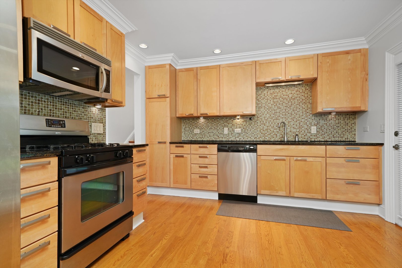5N260 Eagle Terrace Itasca, IL 60143 - Photo 11 of 34 a kitchen with stainless steel appliances granite countertop a stove a sink and a microwave