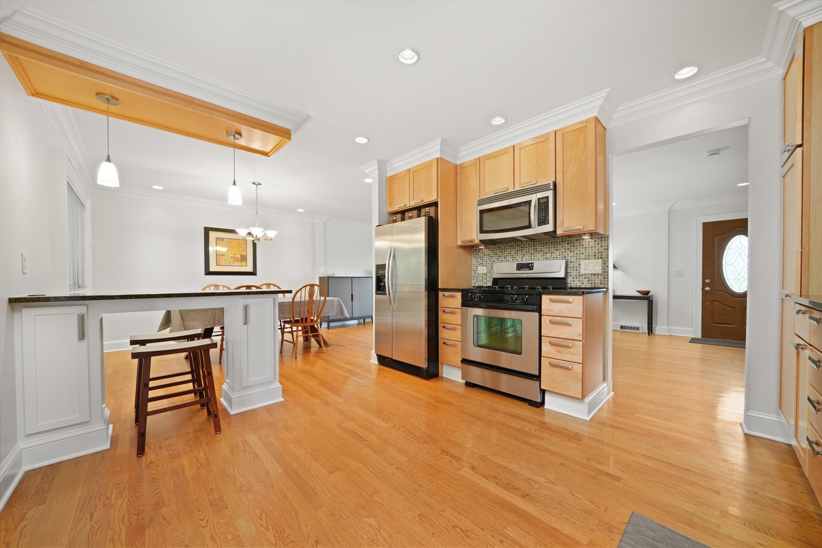 5N260 Eagle Terrace Itasca, IL 60143 - Photo 12 of 34 a kitchen with stainless steel appliances kitchen island granite countertop a refrigerator a stove a oven and white cabinets with wooden floor
