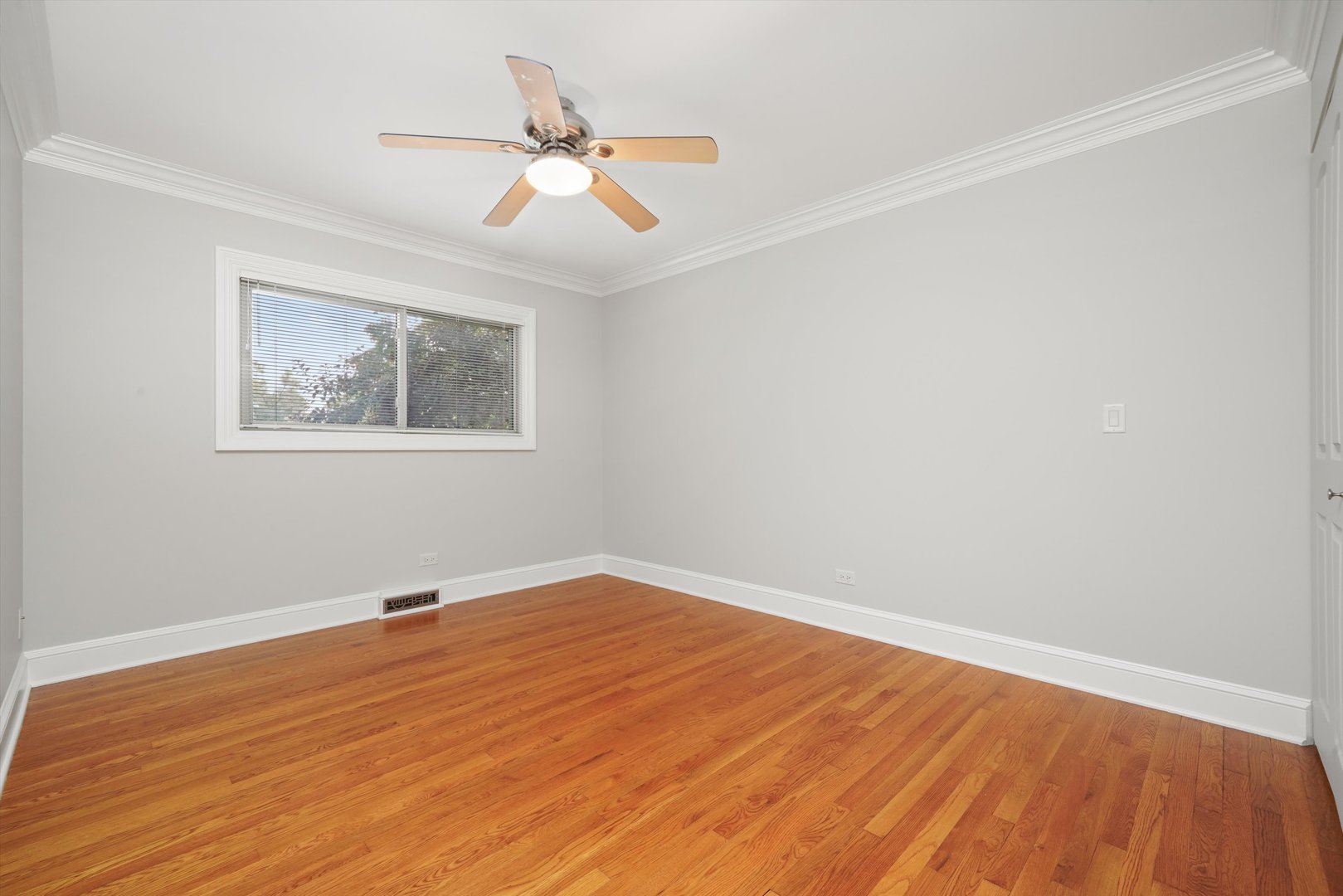 5N260 Eagle Terrace Itasca, IL 60143 - Photo 16 of 34 a view of an empty room with wooden floor and a ceiling fan
