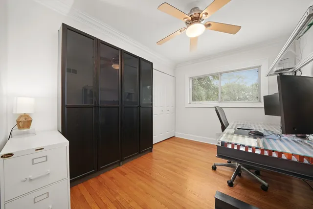 a bedroom with a bed and a flat tv screen on the dresser