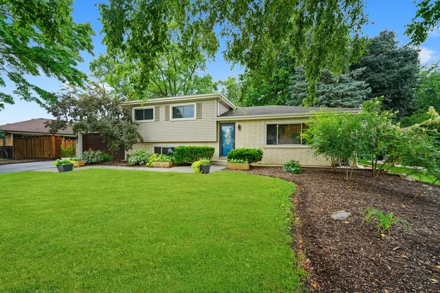 a front view of house with yard and green space