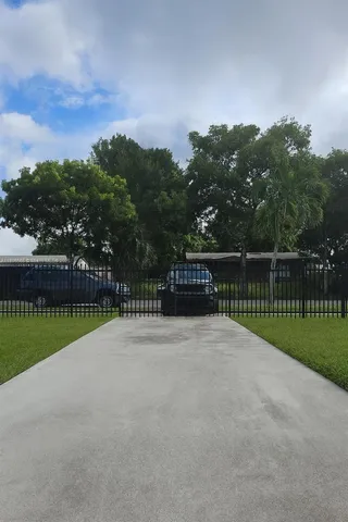 a view of a garden with a building in the background