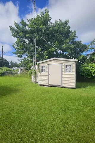 a view of a garden with a building in the background