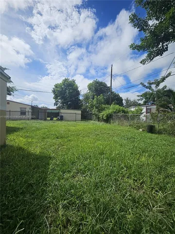 a bedroom with a bed and painting on the wall