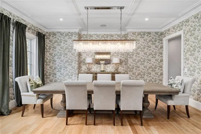 a view of a dining room with furniture wooden floor and chandelier