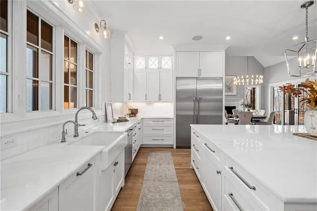 a kitchen with a refrigerator a stove a sink and a cabinets