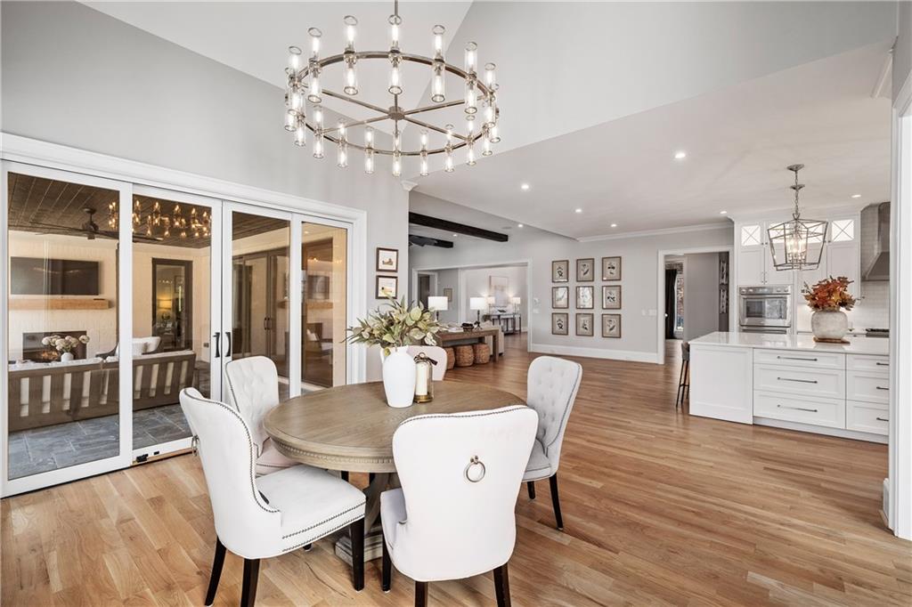 1002 Overlook Terrace Ball Ground, GA 30107 - Photo 25 of 100 a view of a dining room with furniture wooden floor and chandelier