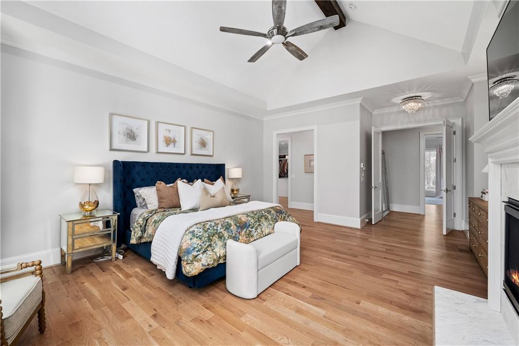 1002 Overlook Terrace Ball Ground, GA 30107 - Photo 30 of 100 a spacious bedroom with a bed and a chandelier