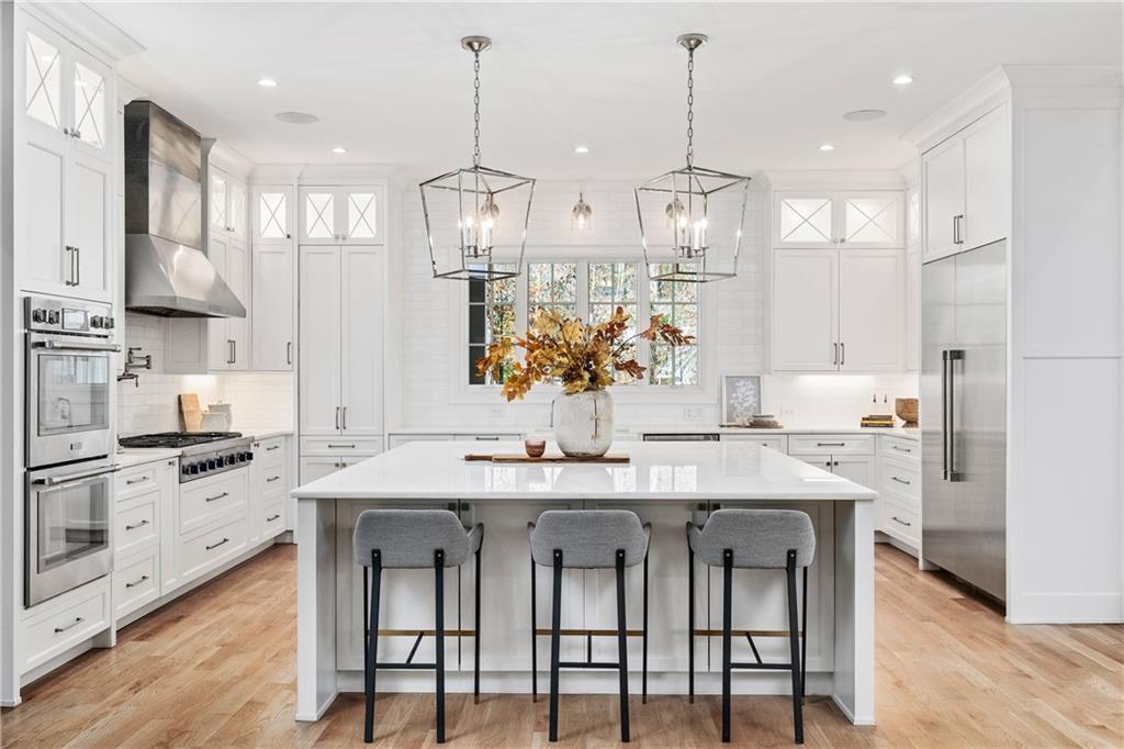 1002 Overlook Terrace Ball Ground, GA 30107 - Photo 3 of 100 a kitchen with stainless steel appliances kitchen island granite countertop a sink and cabinets