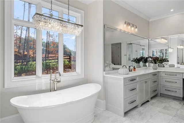 a room with furniture pool table flat screen tv and a chandelier