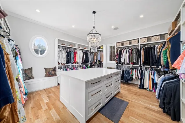 a spacious bathroom with a granite countertop sink a mirror and a shower