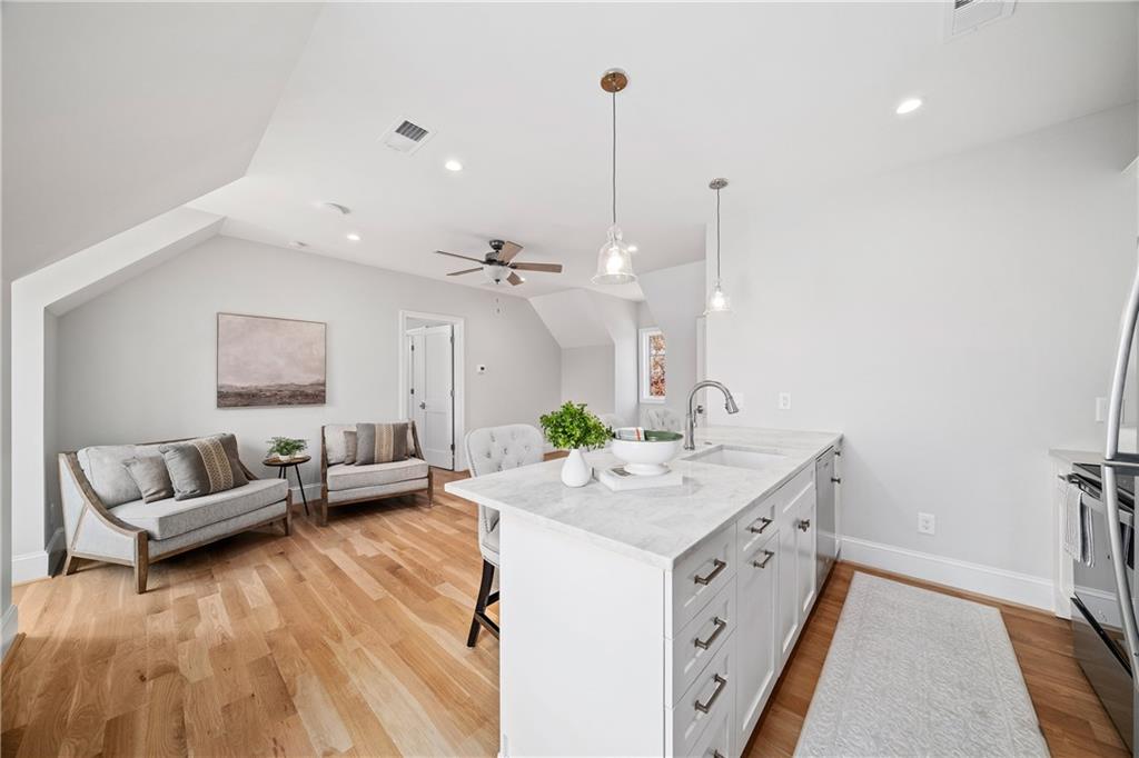 1002 Overlook Terrace Ball Ground, GA 30107 - Photo 42 of 100 a spacious bedroom with a bed and a couch