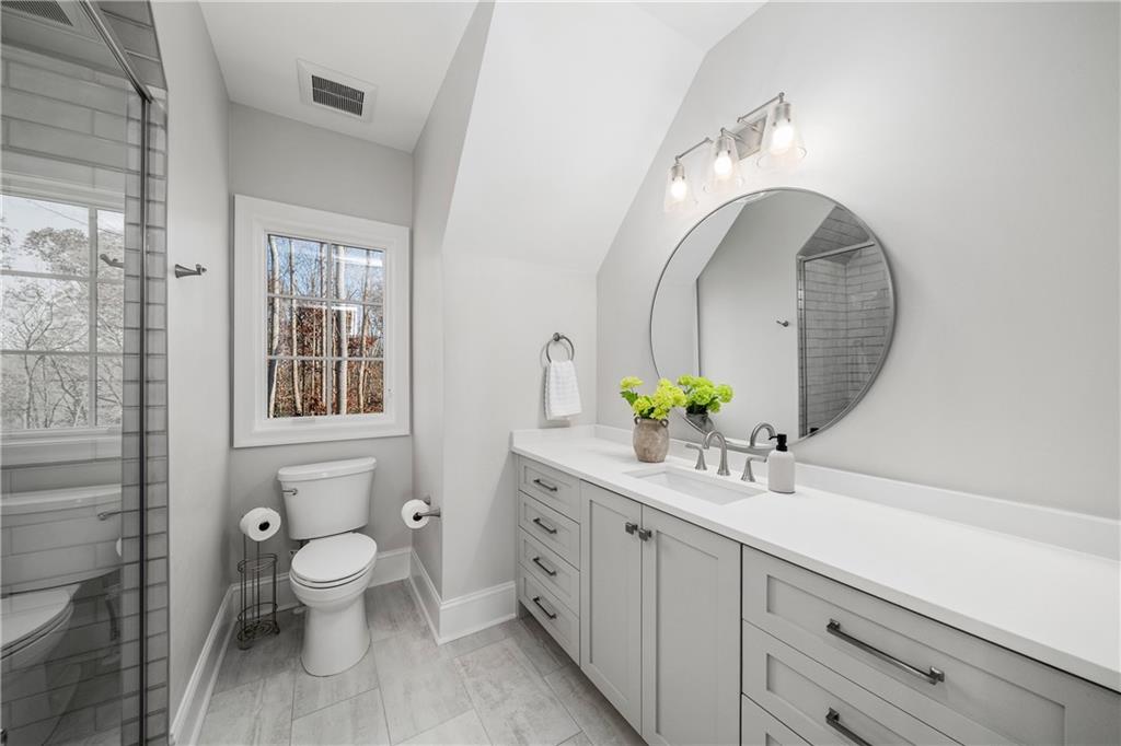 1002 Overlook Terrace Ball Ground, GA 30107 - Photo 44 of 100 a spacious bathroom with a double vanity sink mirror and toilet