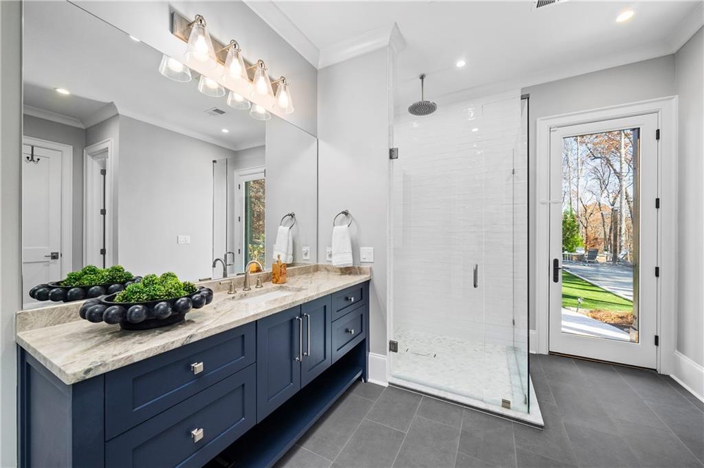1002 Overlook Terrace Ball Ground, GA 30107 - Photo 69 of 100 a spacious bathroom with a granite countertop sink a mirror and a shower