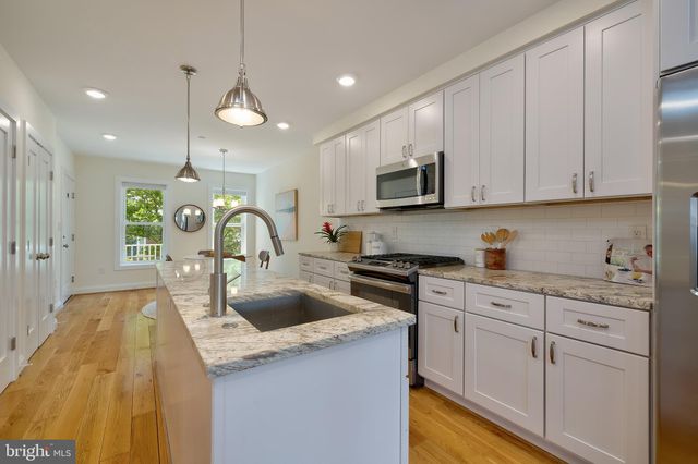 a kitchen with cabinets a sink and appliances