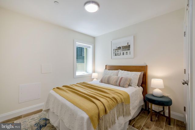 a bedroom with a bed and a lamp with the table