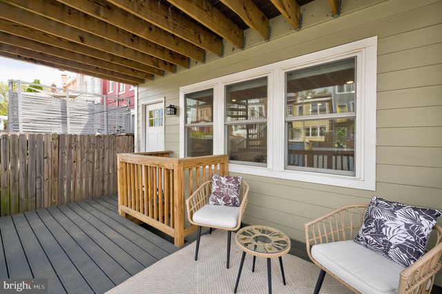 a view of a deck with wooden floor and furniture