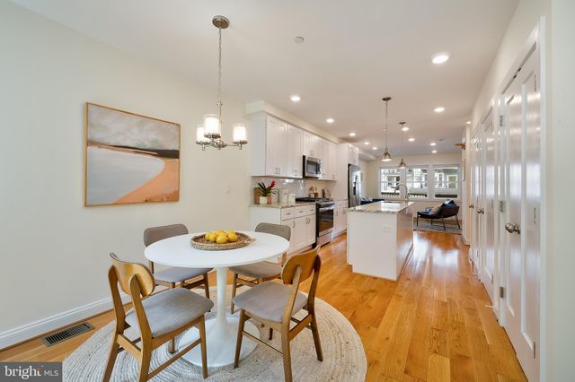 a dining room with furniture and wooden floor