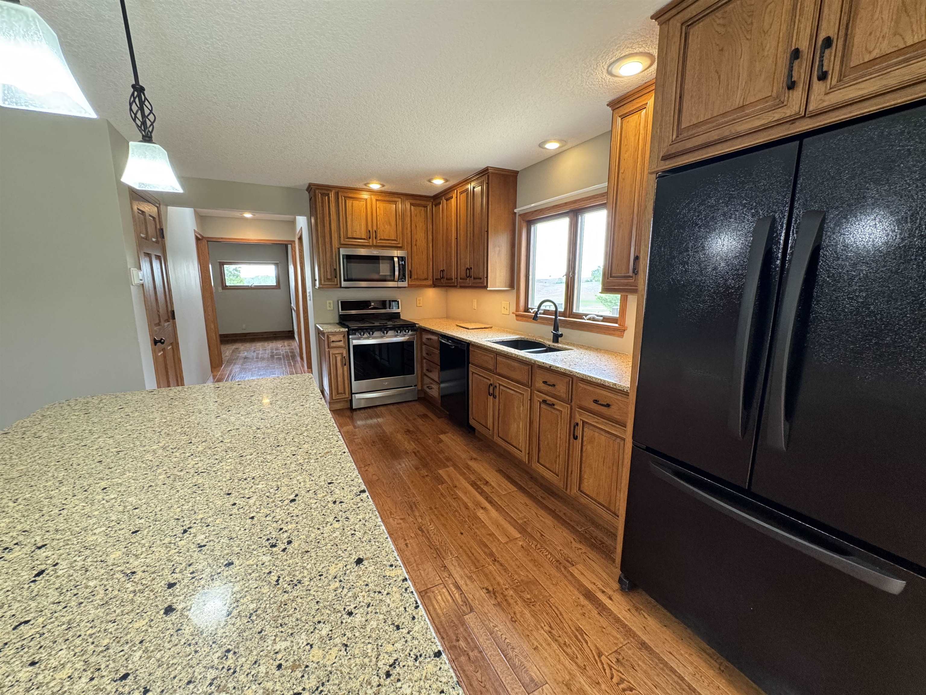 25303 Spring Valley Road Shannon, IL 61078 - Photo 10 of 22 a large kitchen with stainless steel appliances kitchen island granite countertop a refrigerator stove microwave and sink