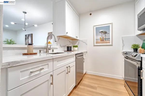 a living room with furniture and kitchen view
