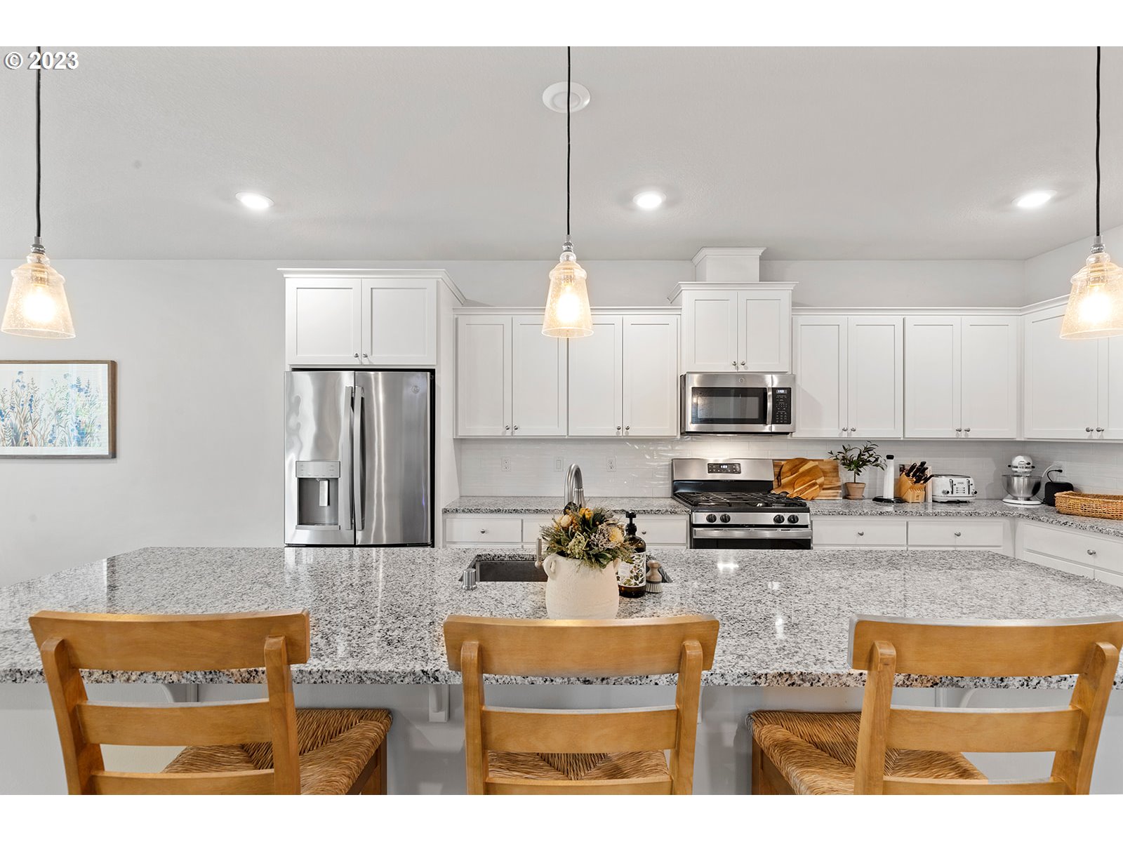 3722 South 39th Place Ridgefield, WA 98642 - Photo 12 of 45 a kitchen with stainless steel appliances granite countertop a sink refrigerator and cabinets