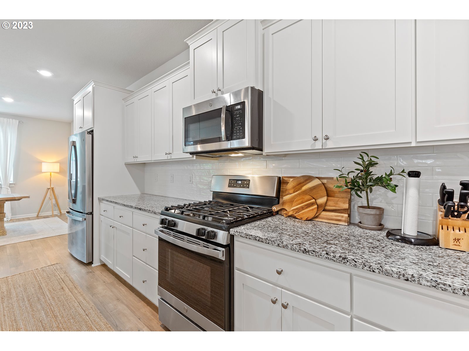 3722 South 39th Place Ridgefield, WA 98642 - Photo 13 of 45 a kitchen with granite countertop a stove sink and cabinets