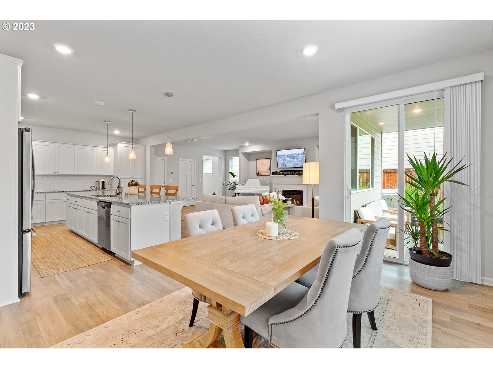 3722 South 39th Place Ridgefield, WA 98642 - Photo 20 of 45 a kitchen with a table chairs refrigerator and microwave