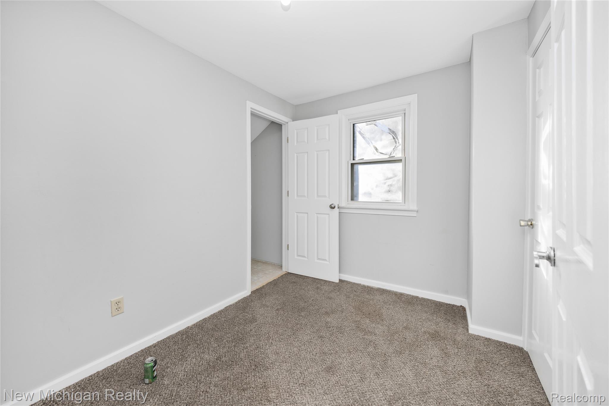 8665 Cooley Lake Road Commerce Township, MI 48382 - Photo 38 of 52 Unfurnished bedroom featuring carpet and baseboards